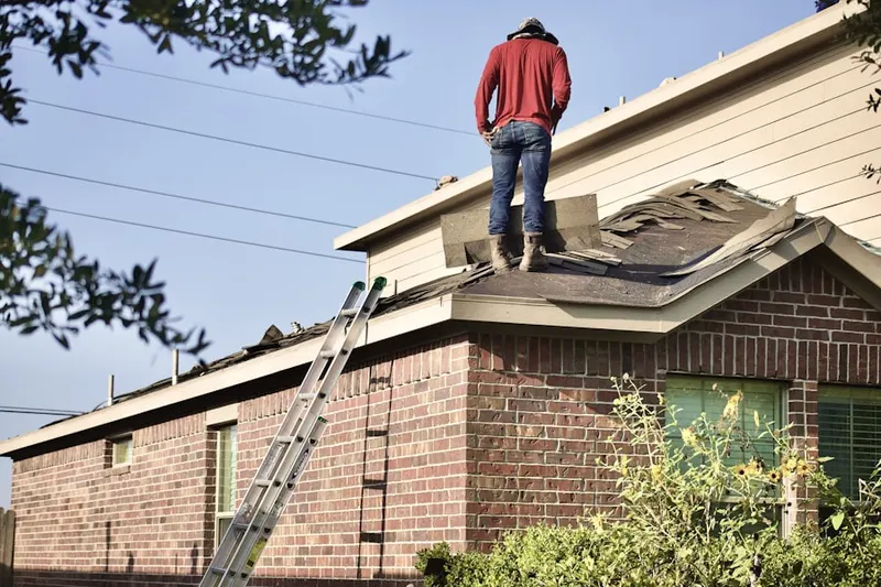 Professional roofer working on a residential roof in Michigan-Glide-Sutter